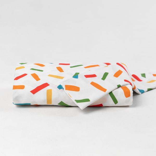 lencol-com-elastico-para-berco-e-fronha-granulado-colorido-dobrado